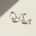 Silver-tone circle hoop earrings with white pearl drop studs