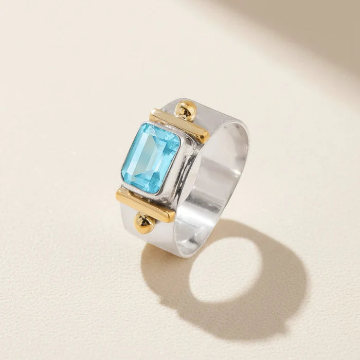 Wide band ring with square sky-blue Topaz-style gemstone in gold bezel