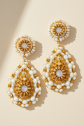 White and gold beaded teardrop earrings with gold hook and dangling beadwork