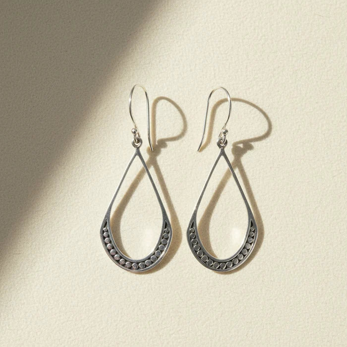 Small silver teardrop beaded earrings with textured border and hanging hook