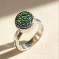 Small round druzy ring with green glitter stone set in silver bezel