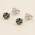 Small rope-knot stud earrings with textured silver-tone round balls
