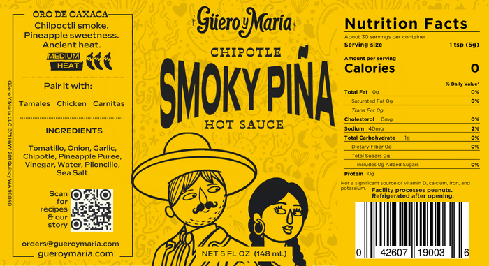 Guiero Maria Chipotle Smoky Piña Hot Sauce label, 5 fl oz (148 mL), featuring a bright yellow background with black text, a QR code, and cartoon illustrations of Guero y Maria.