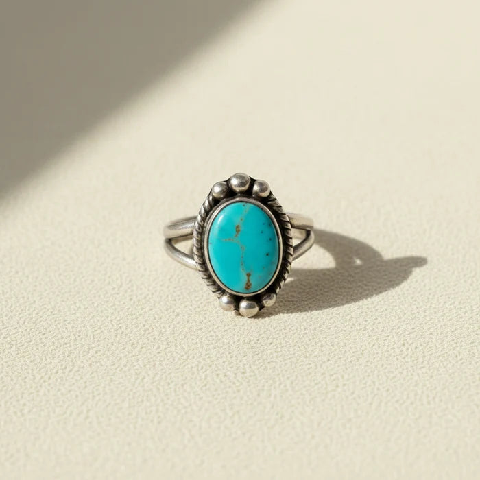 Turquoise oval cabochon ring with silver-tone bezel and bead accents