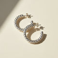 Silver spiral hoop earrings with twisted rope design and latch-back closures