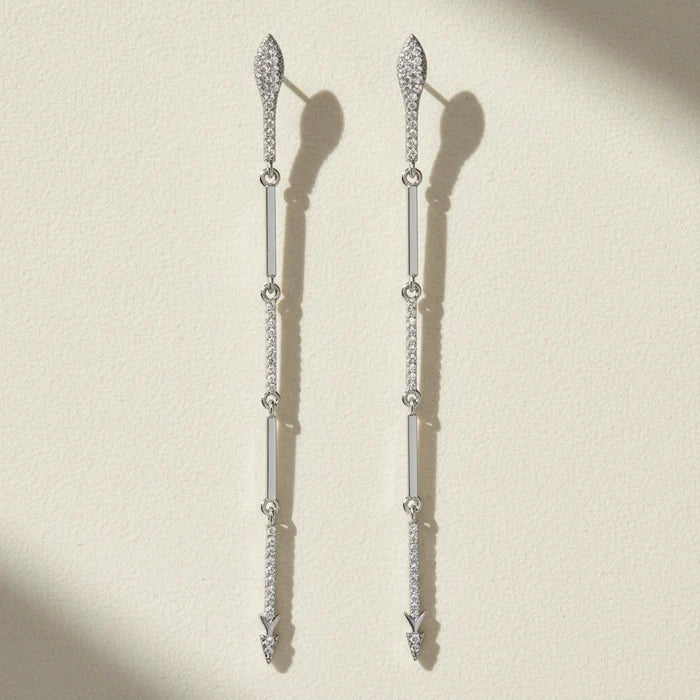 Silver-tone CZ dangle earrings with long drop design and small hanging stone accents