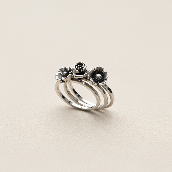Silver ring with floral designs on a white background