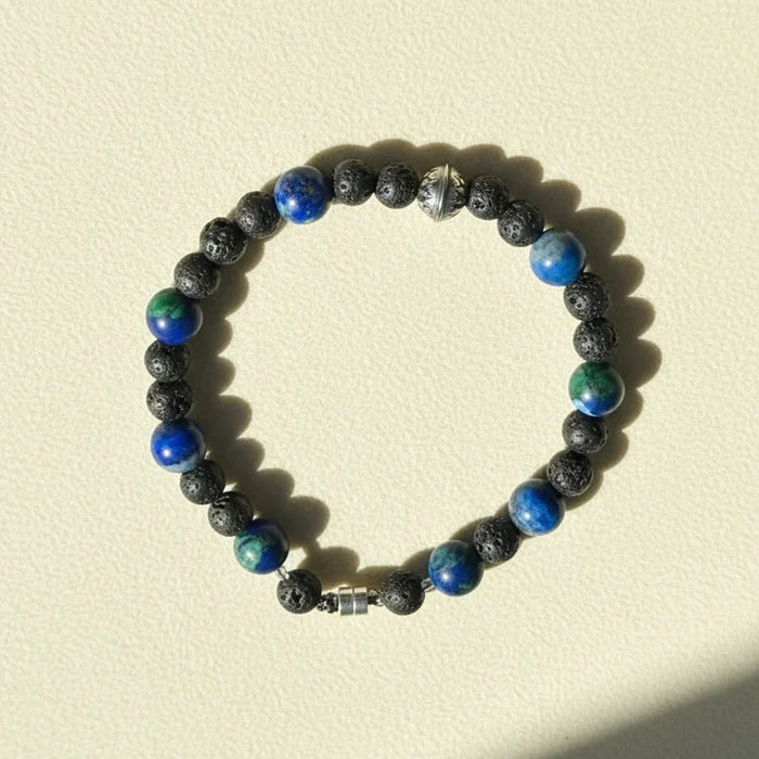 Beaded lava stone bracelet with blue and green gemstone accents, silver clasp