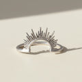 Sunrise ring, silver-tone open band with radiant sunburst rays.