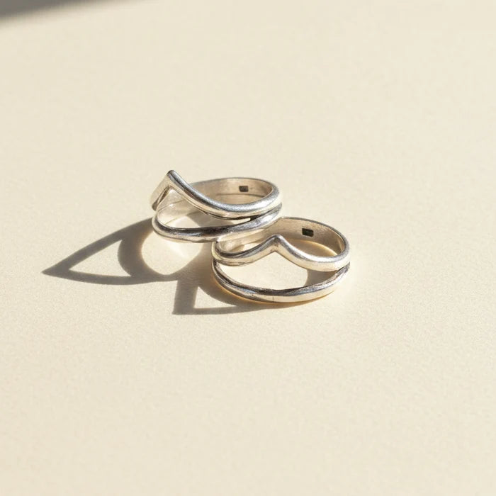 Pair of silver-tone stacked rings with talon-shaped top detail