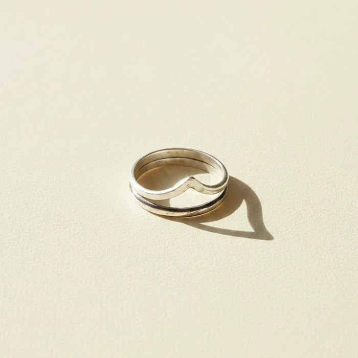Silver-tone contoured band ring with curved center notch