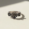Silver flower ring with three bloom medallions on the band