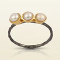 Three pearl ring with white round pearls on gold-tone tops and dark hammered band