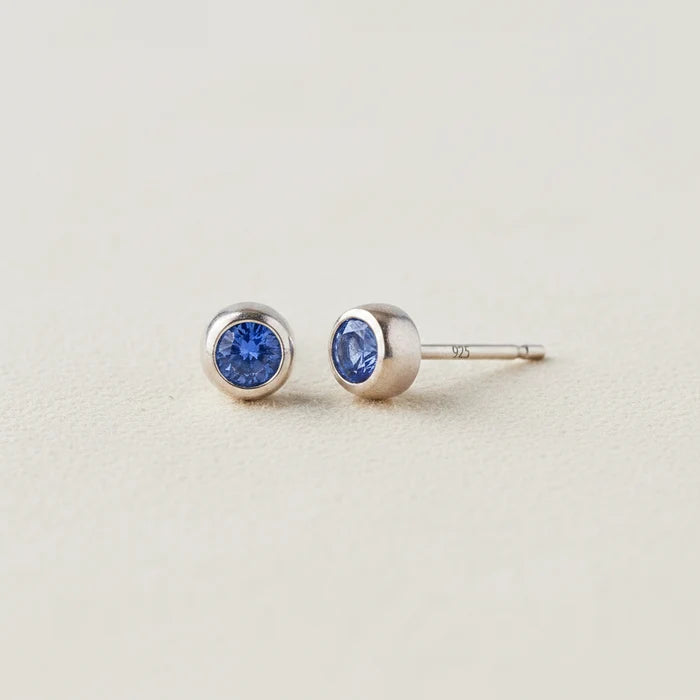 Tiny birthstone stud earrings with round blue sapphire CZ in silver-tone settings