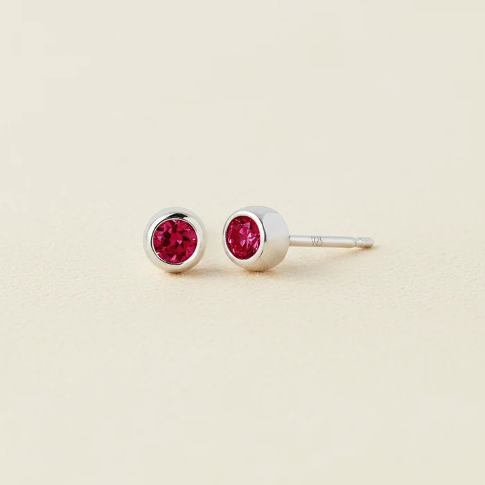 Tiny birthstone stud earrings with round red ruby CZ in silver-tone settings
