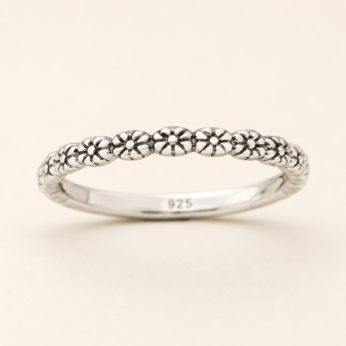 925 sterling silver ring with tiny flower motifs along slim band