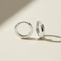 Tiny silver-tone huggie hoop earrings, hinged clasp