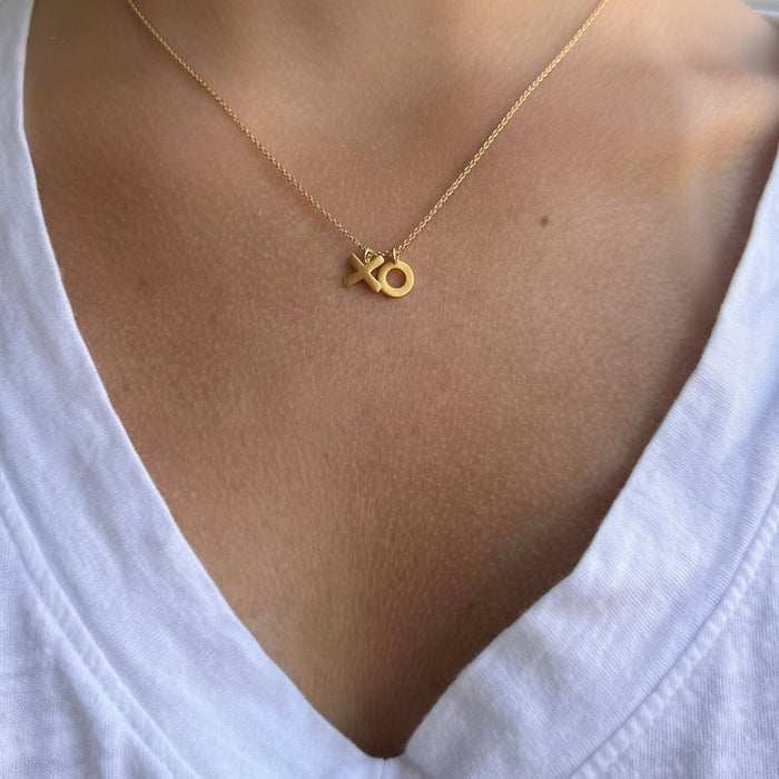 Gold-tone XO charm necklace on short chain