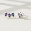 Amethyst pear gemstone stud earrings with three teardrop studs in silver-tone.