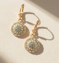 Gold-tone round rhinestone drop earrings with hinged hoops and coin pendants