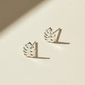 Silver-tone tropical leaf stud earrings with cutout leaf design