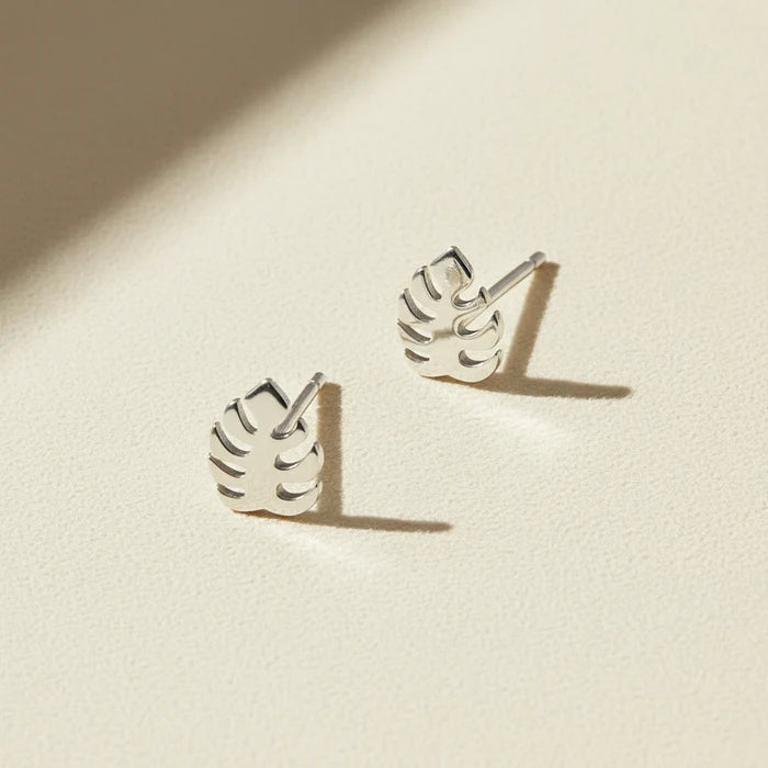 Silver-tone tropical leaf stud earrings with cutout leaf design