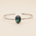Silver bracelet with a turquoise stone on a white background