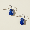 Blue teardrop stone earrings with metal fishhook and dark bezel setting