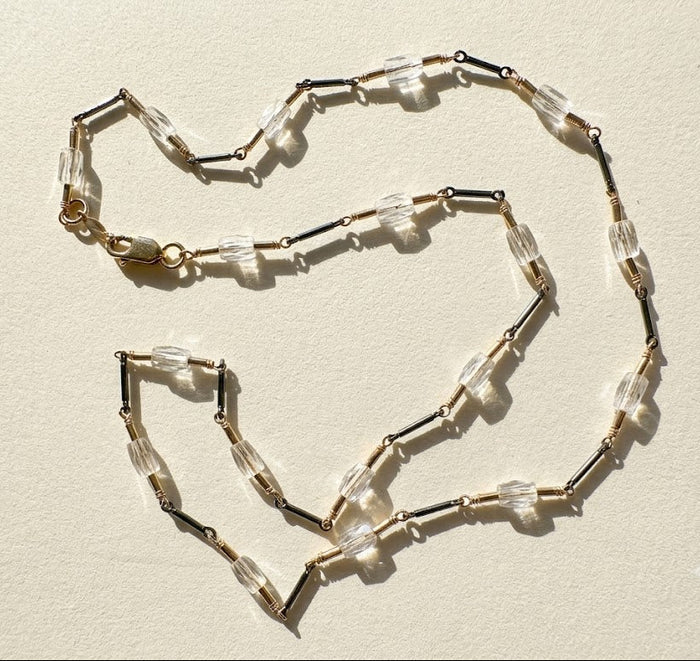 Two-tone crystal choker with clear rectangular crystals, dark beads, and clasp detail