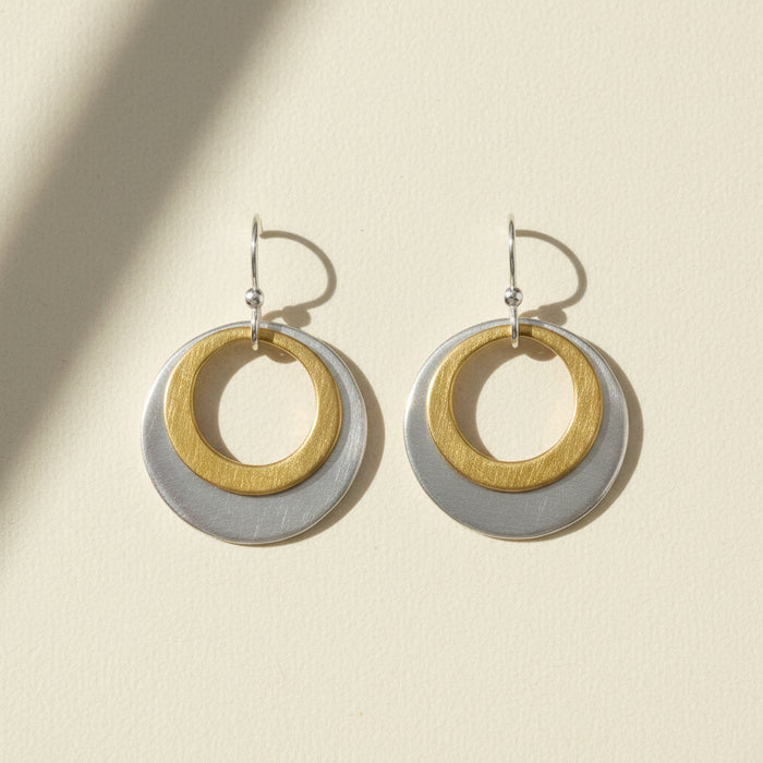 Two-tone double circle earrings with gold inner ring and silver outer disc
