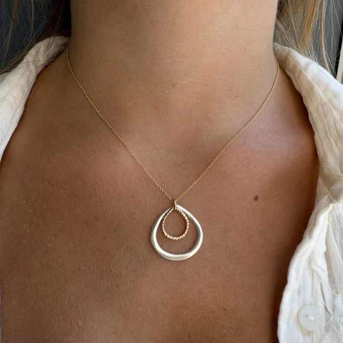 Two-tone double drop necklace with layered teardrop pendant in gold and silver with brown center