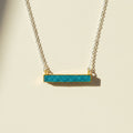 Two-tone druzy bar necklace with aqua blue rectangular pendant on gold chain