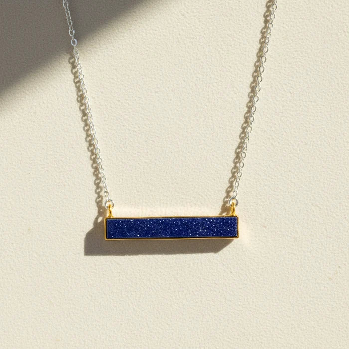 Two-tone druzy bar necklace with dark blue rectangular pendant on gold chain