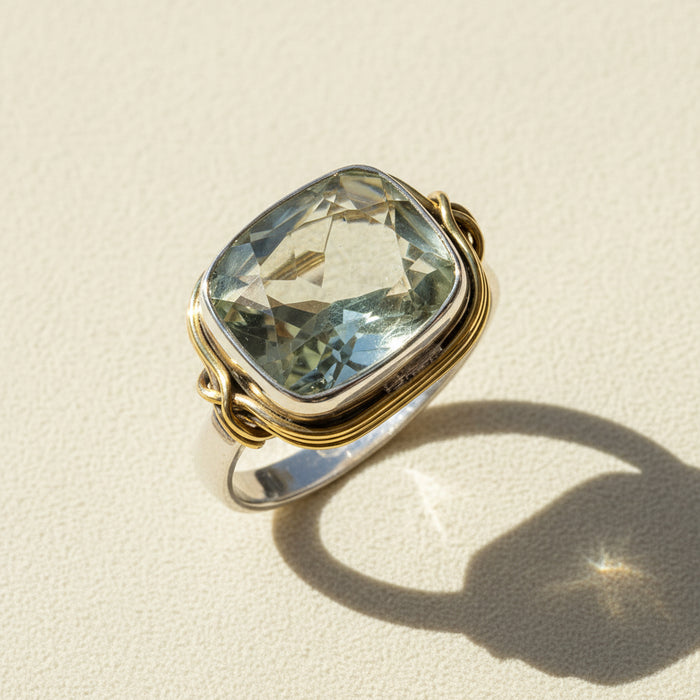 Two-tone ring with large rectangular pale green gemstone and twisted gold and silver band