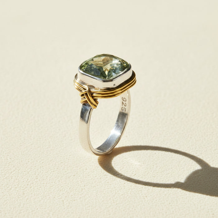 Two-tone ring with rectangular pale green gemstone and inner 925 stamp on band