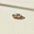 Two-tone hammered spinner band ring in silver and gold, smooth central band