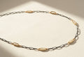 Two-tone seed pearl necklace with alternating metal links and oval pearl stations