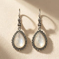 Teardrop crystal drop earrings with dark halo and silver-tone hooks