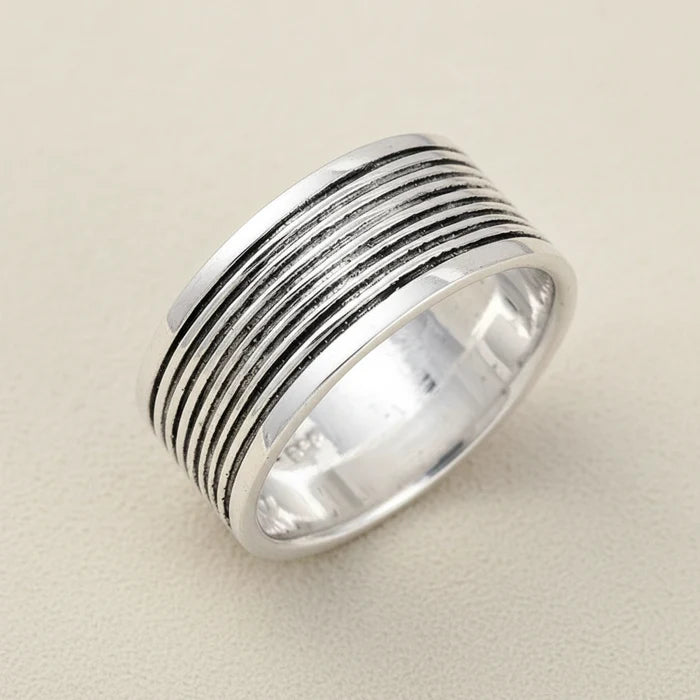 Wide silver-tone grooved band ring with oxidized ridged stripes