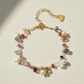 Gold-tone bracelet with freshwater pearls, multicolor gemstones, and heart clasp charm