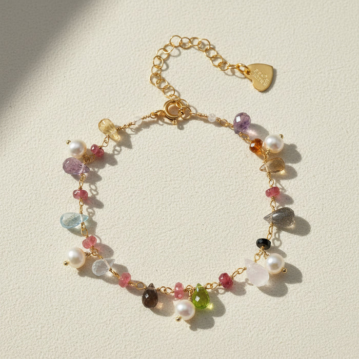 Gold-tone bracelet with freshwater pearls, multicolor gemstones, and heart clasp charm