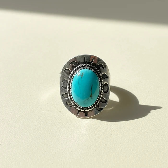 Turquoise oval cabochon silver-toned ring with engraved side details, size 11