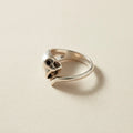Silver cat ring with open mouth detail and dark round eyes